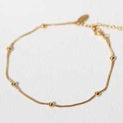 Pulsera de tobillo con bolas doradas