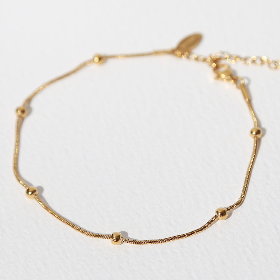 Pulsera de tobillo con bolas doradas