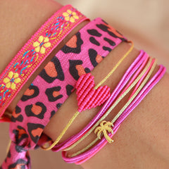 Pulsera tejida flor rosa amarilla
