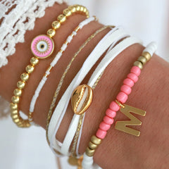 Brazalete mal de ojo dorado rosa